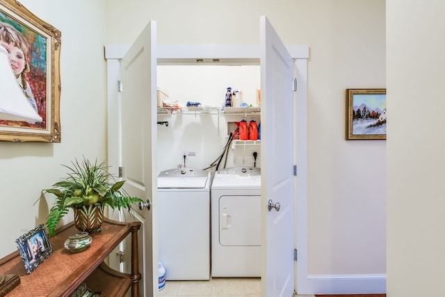 laundry area with light tile patterned flooring and washing machine and clothes dryer