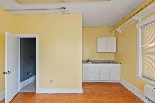 222-R Kimball St, Fitchburg, MA 01420 - kitchen featuring light wood-style floors and white cabinets