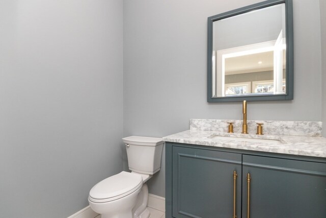 bathroom with vanity, toilet, and tile patterned flooring