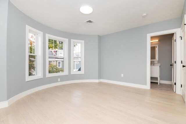 spare room featuring light hardwood / wood-style floors