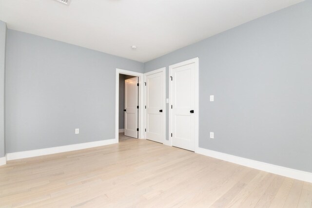 spare room featuring light hardwood / wood-style flooring