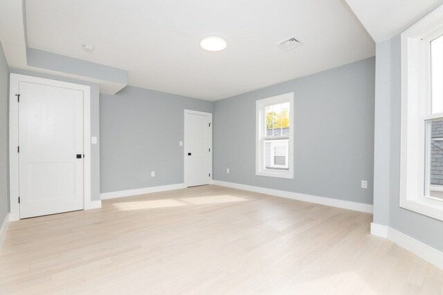 unfurnished room with light wood-type flooring