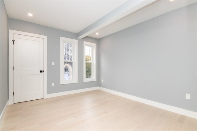 interior space featuring beamed ceiling and light hardwood / wood-style floors