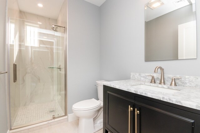 bathroom with toilet, an enclosed shower, vanity, and tile patterned floors