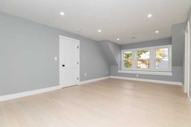 additional living space featuring light wood-type flooring