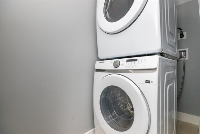 washroom with stacked washer and dryer