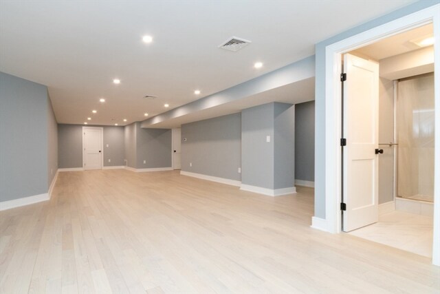 basement featuring light hardwood / wood-style flooring