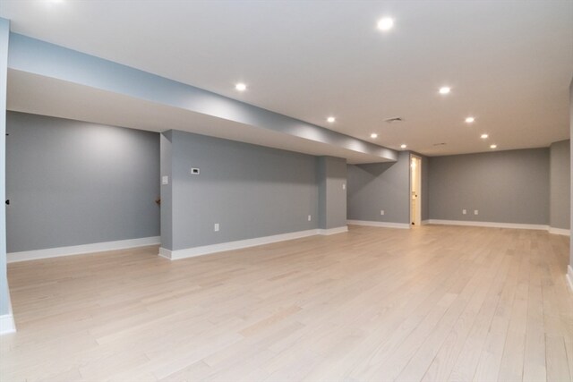 basement with light hardwood / wood-style floors