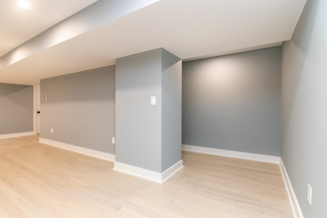 basement with light hardwood / wood-style flooring