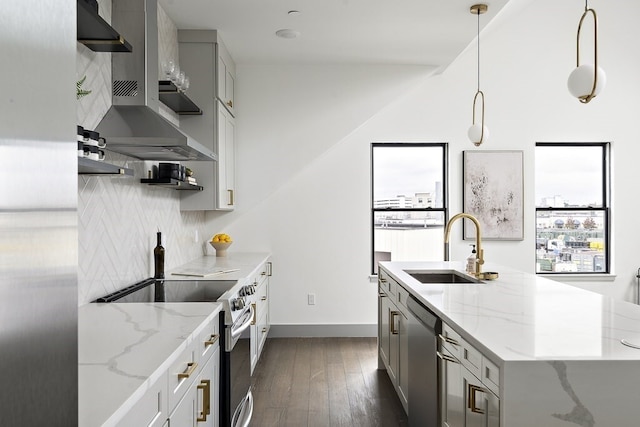 kitchen with decorative light fixtures, light stone countertops, dark hardwood / wood-style flooring, stainless steel appliances, and sink