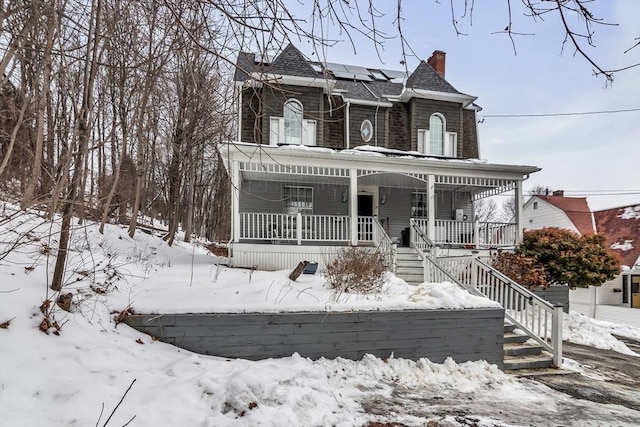 view of front of property with a porch and stairs