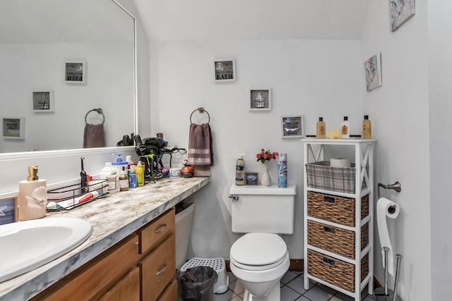 bathroom with tile patterned flooring, vanity, and toilet