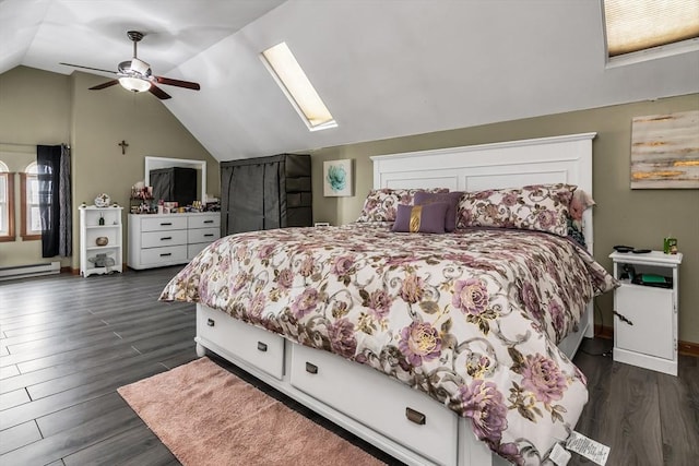 bedroom with vaulted ceiling with skylight, baseboards, a ceiling fan, dark wood-style flooring, and baseboard heating