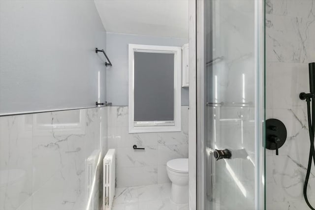 bathroom featuring walk in shower, tile walls, toilet, and radiator heating unit