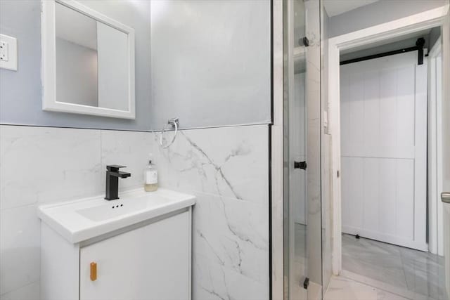 bathroom with vanity and tile walls