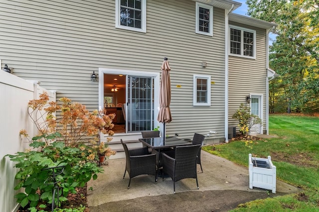 rear view of house with a lawn and a patio area