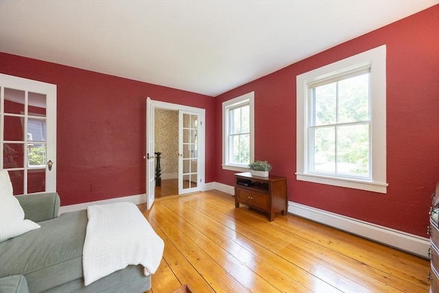 75 Union St, Holliston, MA 01746 - bedroom with a baseboard heating unit, multiple windows, and light wood-type flooring