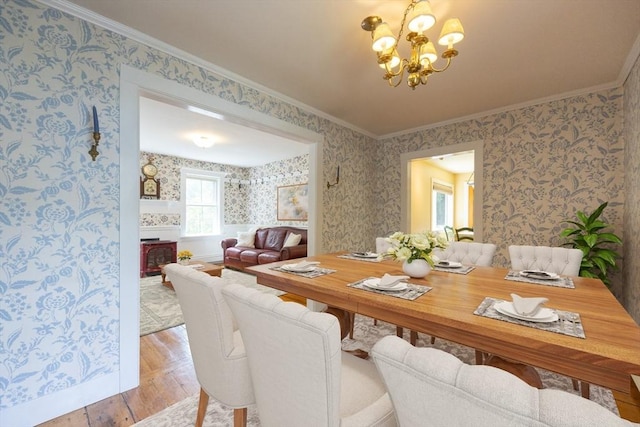 75 Union St, Holliston, MA 01746 - dining area featuring wallpapered walls, a chandelier, crown molding, and wood finished floors