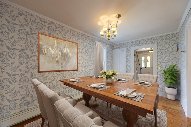 75 Union St, Holliston, MA 01746 - dining space with ornamental molding, a chandelier, baseboard heating, light wood-type flooring, and wallpapered walls