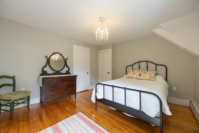 75 Union St, Holliston, MA 01746 - bedroom with a chandelier, wood-type flooring, and a baseboard heating unit