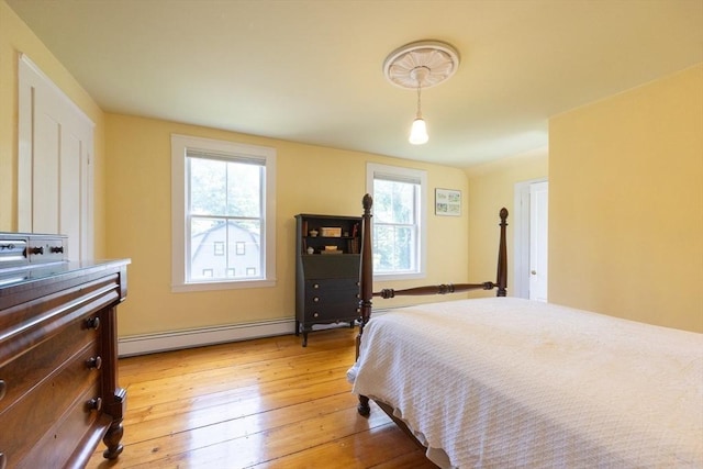 75 Union St, Holliston, MA 01746 - bedroom featuring baseboard heating, multiple windows, and light wood-style flooring