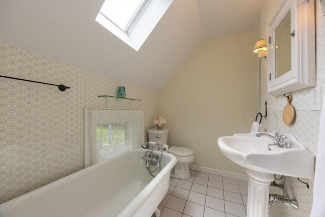 75 Union St, Holliston, MA 01746 - full bathroom with lofted ceiling, a freestanding tub, a skylight, and tile patterned floors