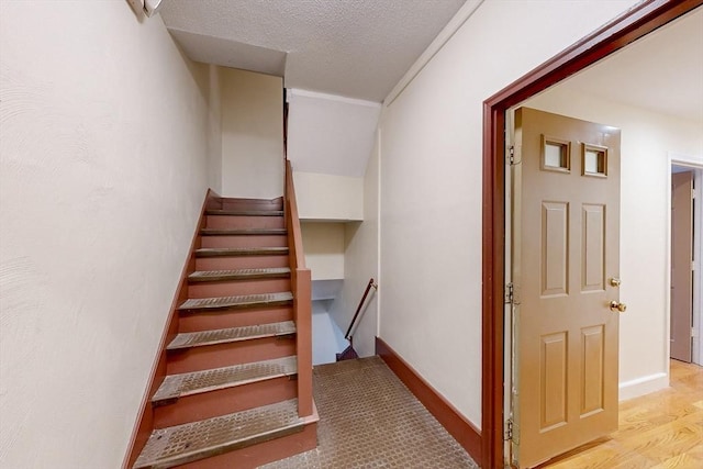 2 Waumbeck St, Boston, MA 02121 - stairs with wood-type flooring and a textured ceiling