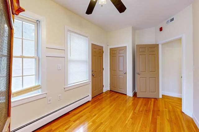 2 Waumbeck St, Boston, MA 02121 - unfurnished bedroom featuring ceiling fan, a baseboard radiator, and light hardwood / wood-style flooring