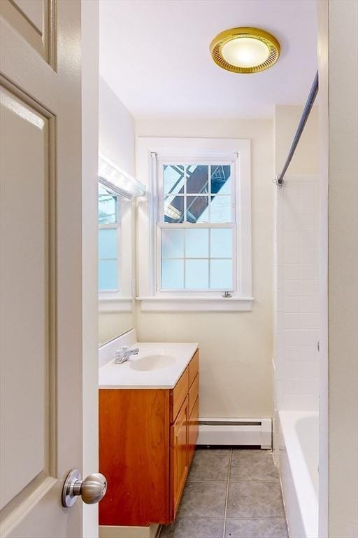 2 Waumbeck St, Boston, MA 02121 - bathroom featuring vanity, tile patterned flooring, bathtub / shower combination, and a baseboard radiator