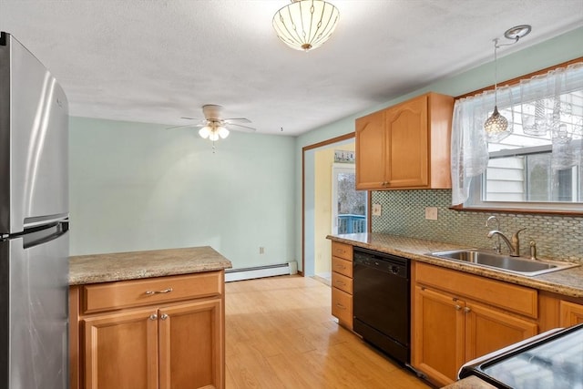 kitchen with backsplash, freestanding refrigerator, a sink, dishwasher, and baseboard heating