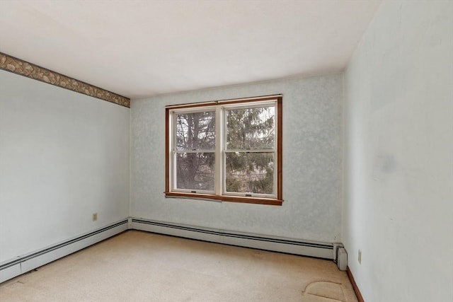 empty room with a baseboard radiator and carpet