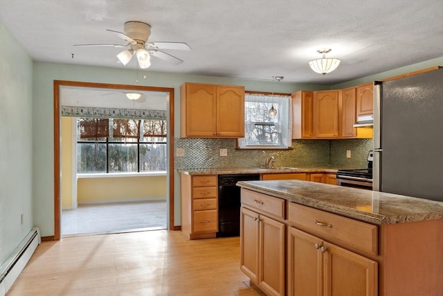 kitchen featuring backsplash, a baseboard radiator, range hood, stainless steel appliances, and a sink