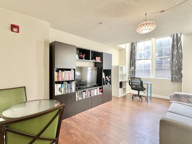 living room with hardwood / wood-style flooring and a textured ceiling