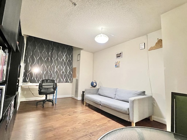 sitting room featuring wood-type flooring and a textured ceiling