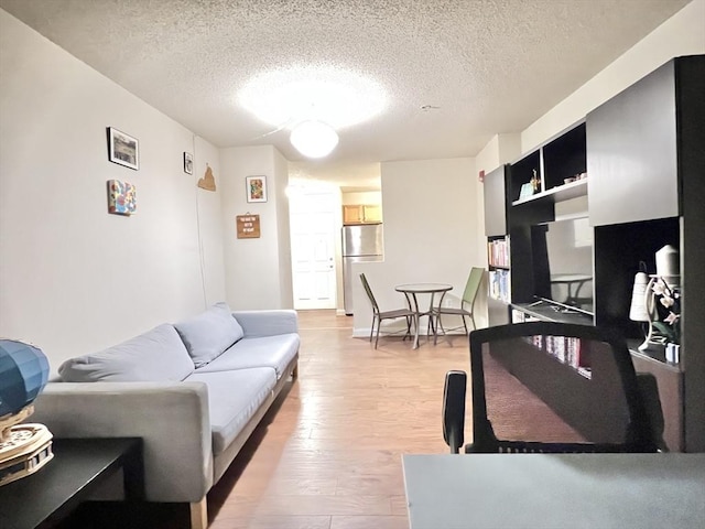 living room with a textured ceiling and hardwood / wood-style flooring