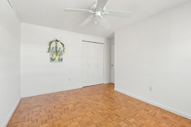 spare room featuring ceiling fan and light parquet flooring