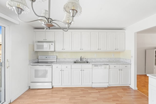 kitchen featuring white cabinetry, sink, white appliances, and light hardwood / wood-style flooring