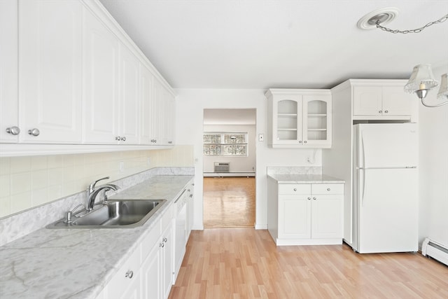 kitchen featuring white appliances, a baseboard radiator, white cabinets, sink, and light hardwood / wood-style flooring