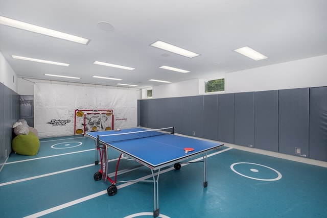 recreation room with concrete flooring