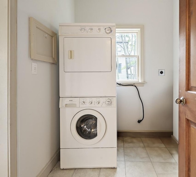 28 Summer St Unit 1, Somerville, MA 02143 - laundry area with stacked washer / drying machine, baseboards, and light tile patterned floors