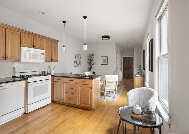 28 Summer St Unit 1, Somerville, MA 02143 - kitchen with white appliances, a peninsula, light wood-style flooring, and plenty of natural light