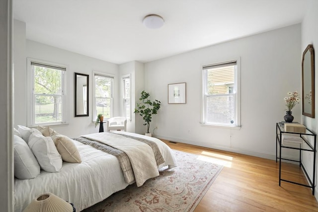 28 Summer St Unit 1, Somerville, MA 02143 - bedroom with multiple windows, light wood-style flooring, and baseboards
