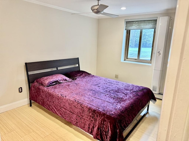 bedroom with baseboards, ornamental molding, a ceiling fan, and wood finished floors