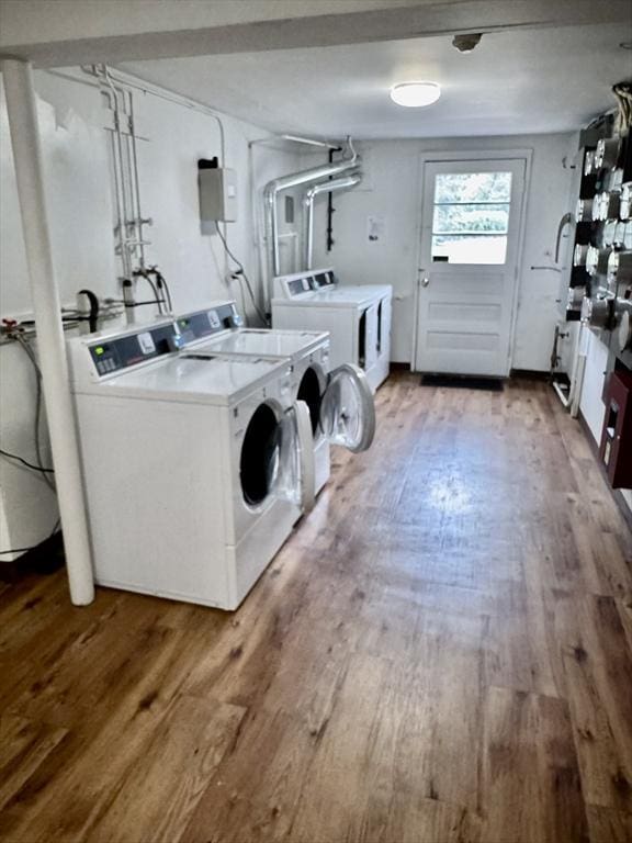 common laundry area featuring washer and dryer and wood finished floors