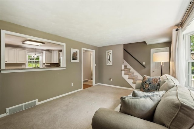 24 S Loomis St, Southwick, MA 01077 - living room featuring baseboards, light carpet, and stairway