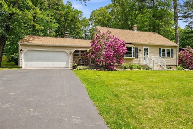 24 S Loomis St, Southwick, MA 01077 - view of front facade with driveway, a garage, a chimney, and a front lawn