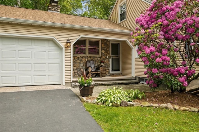24 S Loomis St, Southwick, MA 01077 - doorway to property featuring covered porch, a chimney, stone siding, and asphalt driveway