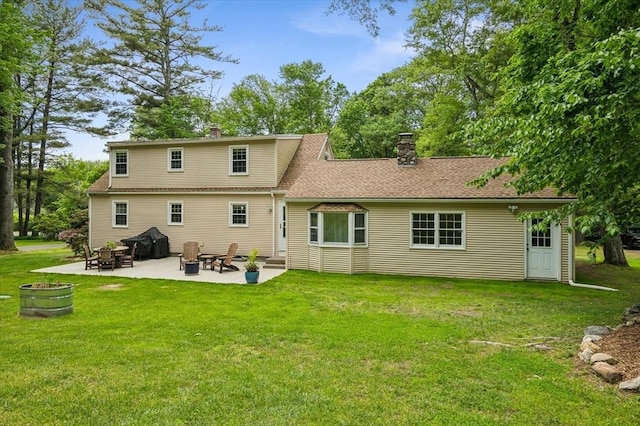 24 S Loomis St, Southwick, MA 01077 - back of house with an outdoor fire pit, a chimney, a patio area, and a lawn