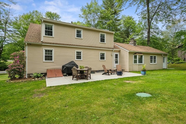 24 S Loomis St, Southwick, MA 01077 - back of house featuring a patio, a lawn, and a chimney