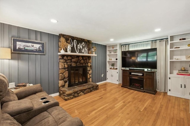 24 S Loomis St, Southwick, MA 01077 - living area with a stone fireplace, wood-type flooring, recessed lighting, and built in features